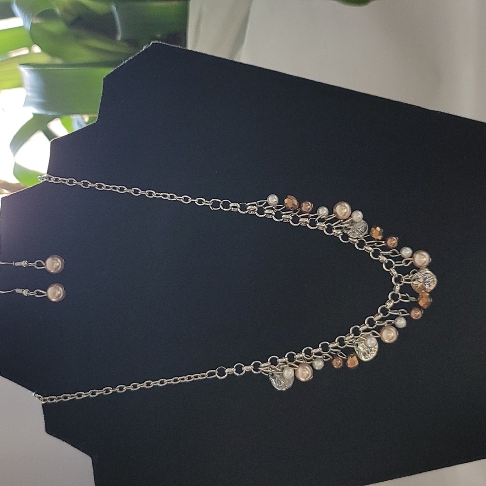 Women's silver necklace and earrings set.